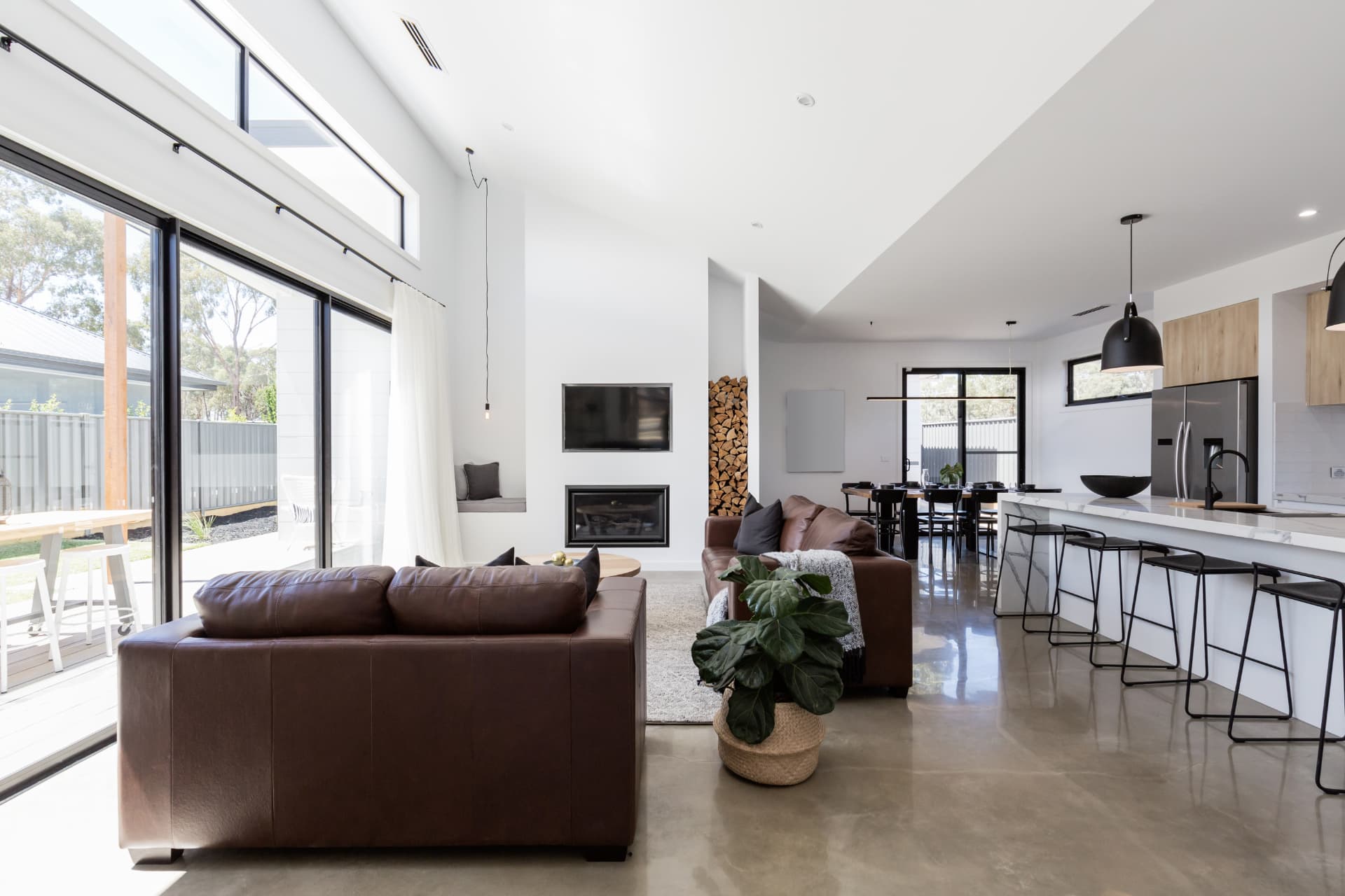 Bright contemporary home interior with living, dining and kitchen areas